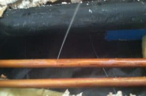 Fine spray from a one sixteenth inch leak between pipes