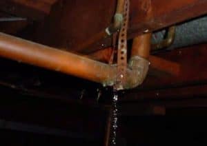 Water spraying from a one thirty-second inch pipe leak
