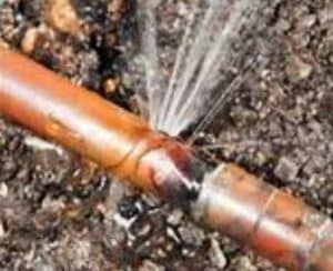 Water spraying from a one fourth inch pipe leak