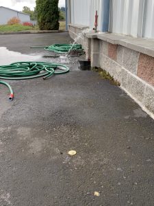 Underground PVC water pipe marked for repair using a pin