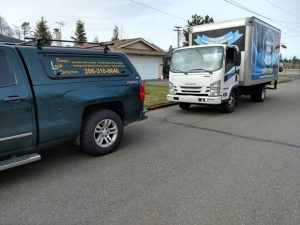 Simply Leak Detection and Trusted Plumbing trucks parked together on site