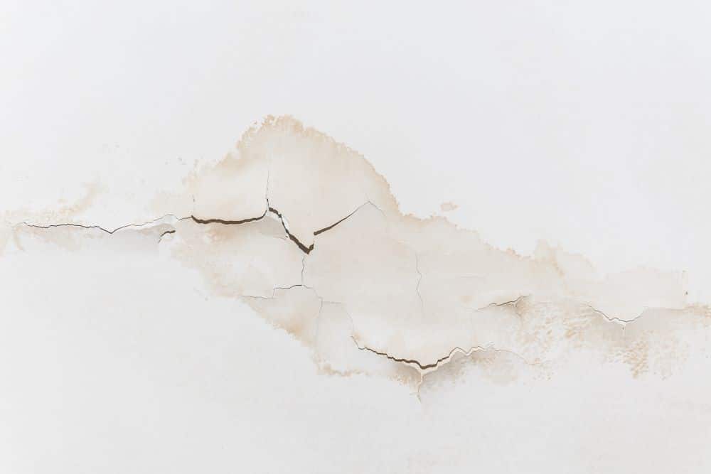 Water-stained and cracked ceiling from an undetected water leak