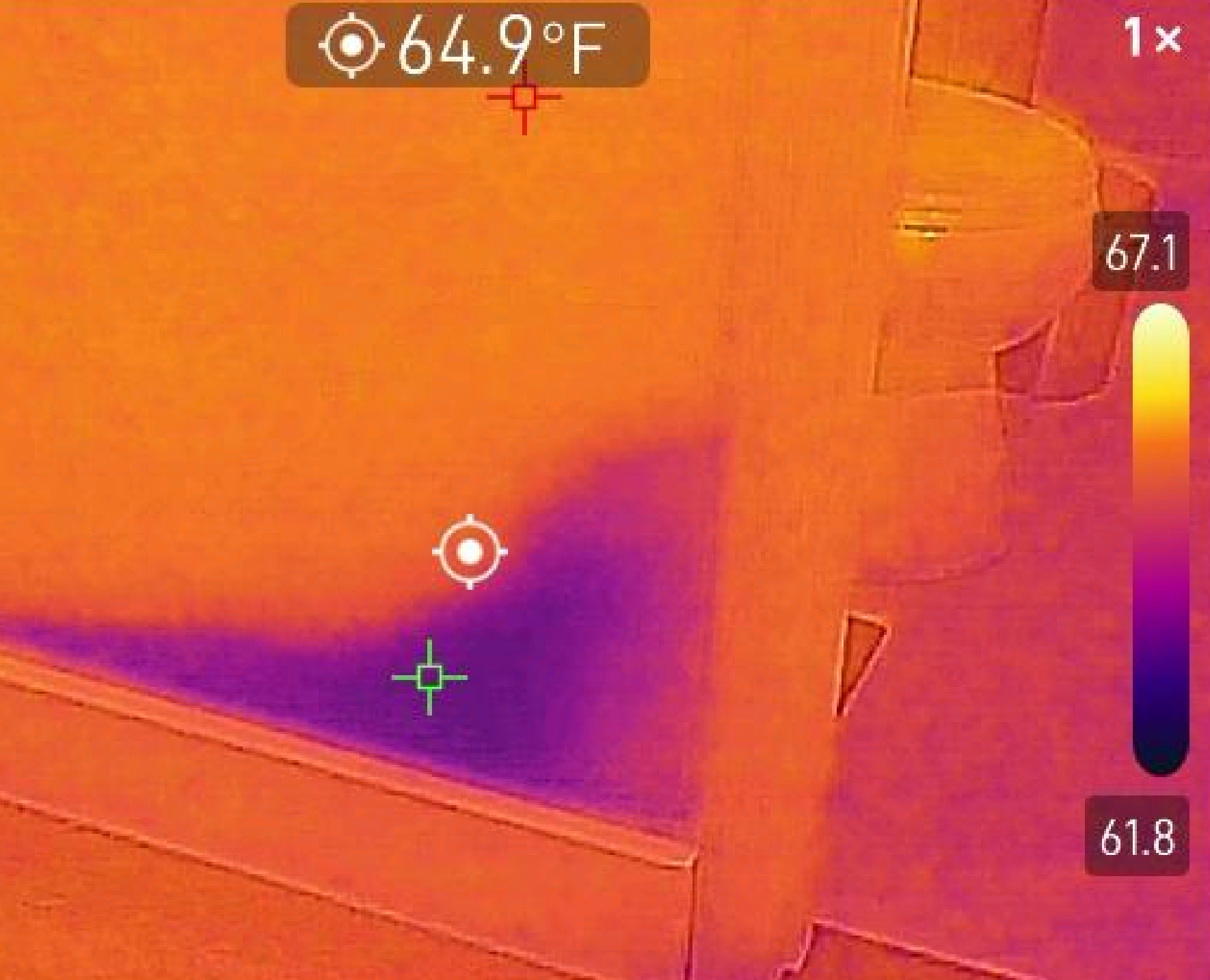 Thermal image showing a cool moisture pattern from a residential wall leak