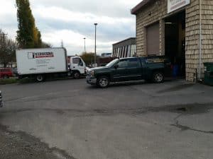 Seattle commercial leak detection service truck connected to a building water system