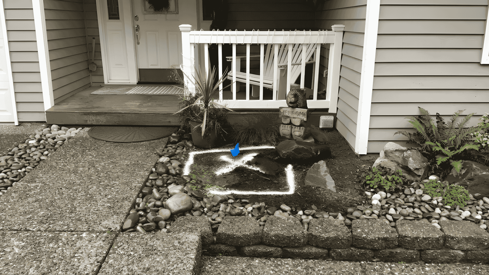 Outdoor residential water-line leak location marked beside a home